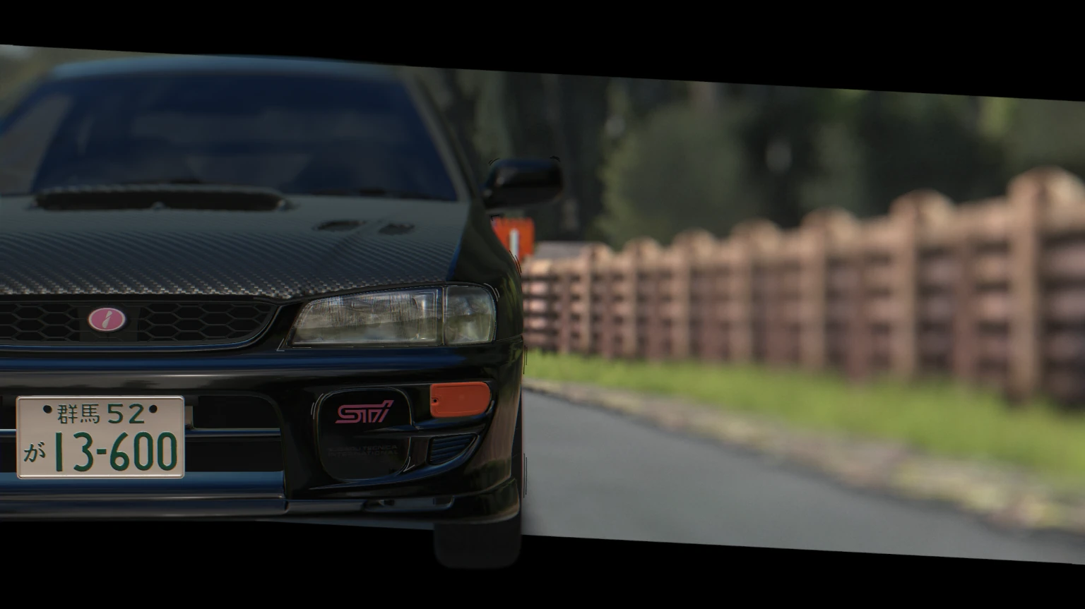 A black Impreza GC8 STi up close on a country road